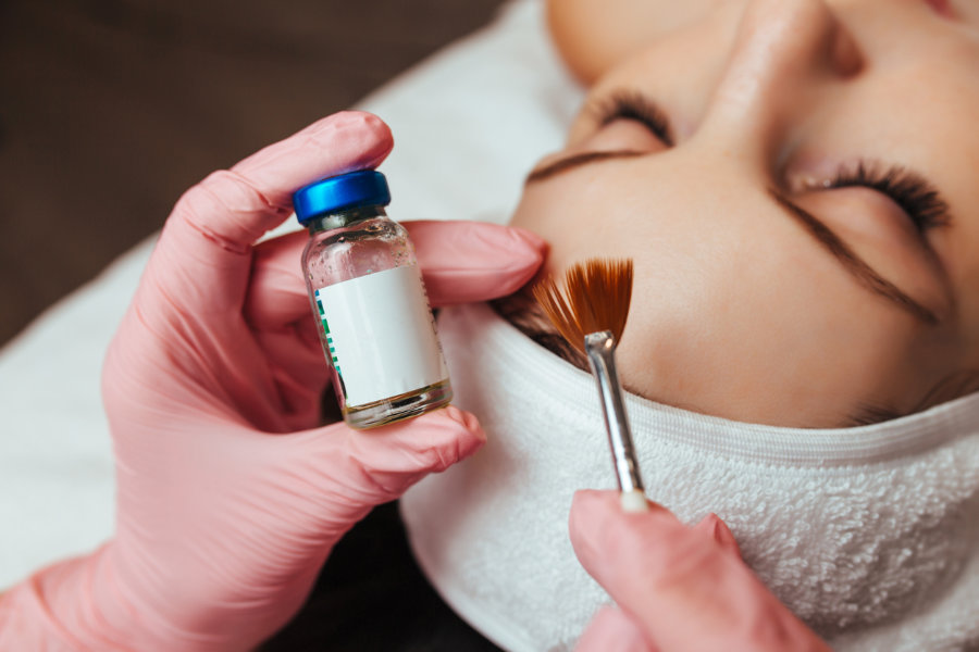 Chemical peel being brushed on forehead